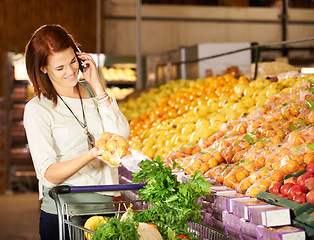 Image showing Woman, talking and smartphone with vegetable shopping for healthy food, supermarket and communication. Happy, person and call on cellphone at grocery retail, fruit and wellness store for nutrition