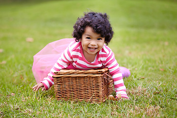 Image showing Portrait, happy child and basket for picnic in park with laugh, smile and fun. Girl. curly hair and natural in pink tutu for imagine, game or whimsical activity for growth, wellness or development