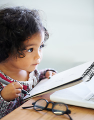 Image showing Drawing, learning and a child with a book for notes, creativity and art at a table. House, study and a girl, kid or baby writing in a notebook for education, learning or a picture on paper at home