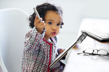 Image showing Thinking, playing and a child with a notebook for drawing, art and creativity for a home hobby. Idea, inspiration and a girl, kid or baby with paper for education, learning and a picture at a desk