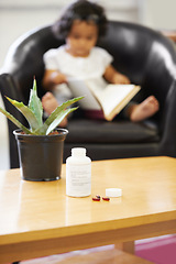 Image showing Pills, bottle and young child reading for adhd diagnosis, school work learning or education. Medication, capsules or daughter or book concentration in home development discipline, childhood or growth