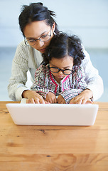 Image showing Remote work, typing and a mother with a child and a laptop for communication, email or connection. House, care and a woman with a girl kid and a computer for freelance, entrepreneur or a web job