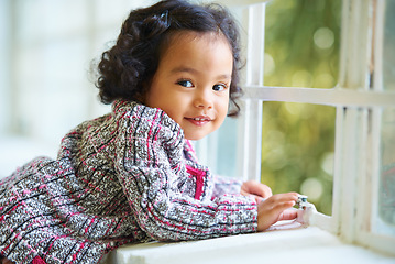 Image showing Little girl, portrait and smile at window for relax, child development or happiness. Female toddler person, cute face and joyful play in home or learning growth, thinking or dress up clothes in room