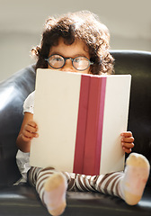 Image showing Child, portrait or glasses book read for fun education, learning or childhood development knowledge. Little girl, face on sofa for notebook studying or dress up as professional, school work or play