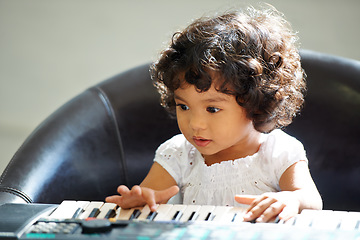 Image showing Girl, child and keyboard music play for childhood learning, education development or lessons. Female person, kid and piano keys song or instrument training knowledge, youth artist or future musician