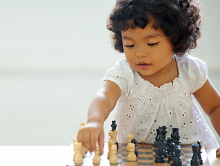 Image showing Girl, child and chess play for learning growth, childhood development or thinking challenge. Female person, board game and table problem solving intelligence or kids, planning knowledge or education