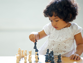 Image showing Toddler, girl and chess play for learning growth, childhood development or thinking challenge. Female person, board game or table problem solving intelligence or kids, planning knowledge or education