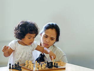 Image showing Mother, child and chess play for learning growth, development challenge or bonding time. Girl, woman or board game fun for problem solving intelligence or kids lesson, planning knowledge or education