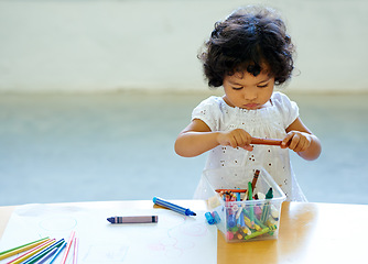 Image showing Young girl, crayons and drawing in classroom for creative development, education growth in kindergarten. Child, daycare or table pencils artwork for learning play school or paper, craft idea or color