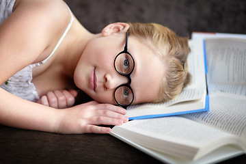 Image showing Portrait, learning and a child reading a book for knowledge, studying or to relax on the floor. Library, young and a girl, kid or a student at school with a novel, story or getting ready for an exam