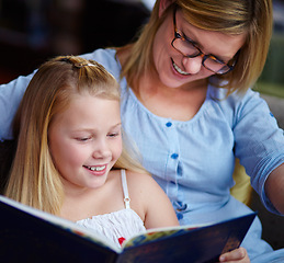 Image showing Reading, story and mother with child in home with smile, learning and relax with study knowledge. Storytelling, happy mom and girl on library couch together with books, fantasy and education.