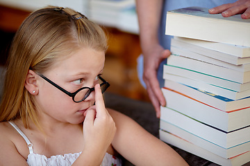 Image showing Thinking, concern and a child with books at a library for education, knowledge and learning. Looking, worry and a girl, kid and librarian with textbooks for studying, hobby or homework at school