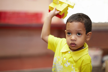 Image showing Boy, education and building blocks in classroom for development, scholarship and thinking at kindergarten. Happy student child, plastic toys and playing with idea for learning, academy or preschool