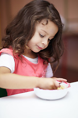 Image showing Girl child, bowl and eating at kindergarten with thinking, nutrition and learning with food on desk. Kid, diet and hungry at table for wellness, health and ideas at lunch, relax and preschool class