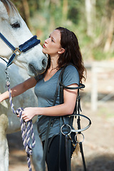 Image showing Care, horse riding or woman in countryside outdoor with rider or jockey for recreation or wellness. Kiss, bridle or closeup of athlete with a healthy animal for training or support on farm in Texas