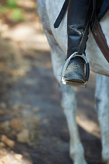 Image showing Boots, horse riding or jockey in countryside outdoor with rider or person for recreation or wellness. Exercise, travel or closeup of athlete with a healthy animal for training or support on farm