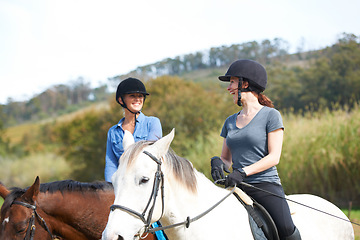 Image showing Women friends, horse riding and talk with smile in helmet, ranger team and equestrian exercise. Girl outdoor together, jockey and chat on adventure, training or learning for contest in countryside