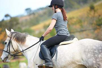 Image showing Horse riding, back or woman in countryside outdoor with rider or jockey for recreation or wellness. Sports, ready or equestrian with a healthy animal to start training, exercise or workout on farrm