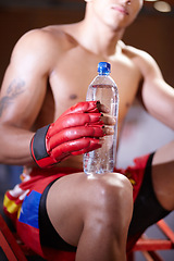Image showing Man, boxing and hands with water bottle for workout or fight in ring, match or training in gym. Health, fitness and fighter with a drink in exercise or rest break for wellness in fighting competition