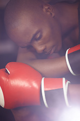 Image showing Fitness, thinking or sad boxer after loss, failure or defeat in combat or sports battle in a boxing ring. Black man, loser or frustrated African fighter feeling bad, depressed or upset with stress