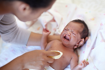 Image showing Newborn, crying and cleft palate with cleaning, mom and bed with parent, sick and frustrated. Medical issue, syndrome and home bedroom for healthcare, childcare and mouth for baby, pain and sadness