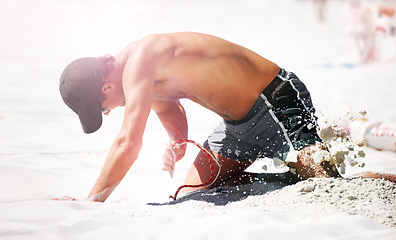 Image showing Man digging at beach in sand for volleyball, sports and exercise for body health. Person outdoor kneeling in dirt with rope to set up net for workout, training and practice game in summer for fitness