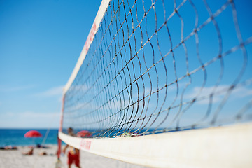 Image showing Volleyball, net and beach with blue sky outdoor for game, competition or match. Ocean, sports netting closeup or sand field for training, exercise and workout, fitness or sea for recreation in summer