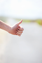 Image showing Person, travel and hitchhike on highway for car, stop and adventure on road trip with transportation for freedom. Man, vacation and help with journey, countryside and hand sign in cape town in mockup