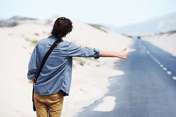 Image showing Back, man or hitchhiker in nature on road for travel, destination or road trip with thumbs up in street. Rear View, person or hand gesture outdoor or hitchhiking, transportation and waiting in summer