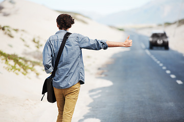 Image showing Man, travel or hitchhiking on highway for car, stop or adventure on road trip with transportation for freedom. Young person, summer or countryside for help with journey, cape town or outdoor