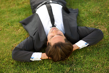 Image showing Relax, grass and a business man lying on a field outdoor from above for the success of a completed task. Sleep, dreaming or rest with a corporate employee chilling at a garden or park in summer