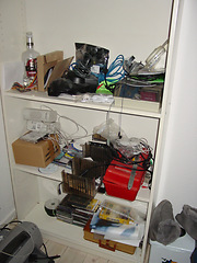 Image showing Room, messy and shelf with tools and equipment for cleaning, cables and dirt in home or background. Apartment, dirty and cupboard with shelves, disorganized and cords in bedroom of house for display