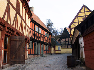 Image showing Vintage, countryside and a village with homes for travel, tourism or sightseeing. City, landscape and a road, alley or street with houses for retro or medieval culture or architecture in Europe