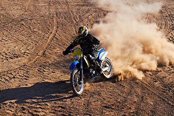 Image showing Man, motorcycle and bike dust cloud as professional rider in action danger competition, fearless or race. Male person, transportation or fast speed dirt adventure or rally, challenge gear or driving