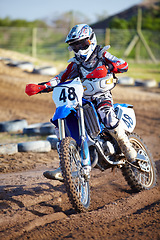 Image showing Person, motorcycle and dirt race track adventure as .professional in action, danger or fearless risk. Bike rider, off road course and fast speed competition rally, extreme sport gear on sand path