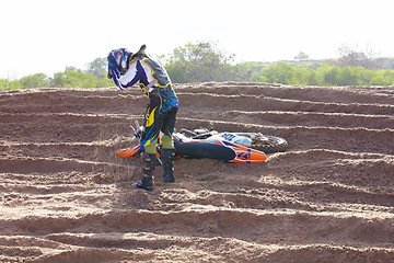 Image showing Accident, sports and man biker on a dirt road for competition, race or training workout. Fitness, motorcycle and frustrated male athlete with mistake on bike in outdoor sand dunes or desert for hobby