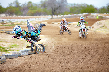 Image showing Sports, accident and man biker in a race on a dirt road in the desert with competition for hobby. Fitness, training and male athlete falling off bike and driving in a sand dune for adventure workout.