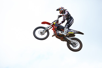 Image showing Person, motorcycle and air jump adventure as professional in action, competition or fearless. Bike rider, off road transportation stunt or fast speed blue sky or rally, extreme sport or challenge