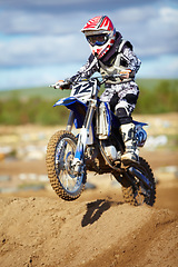 Image showing Man, motorcycle and bike hill jump as professional rider in action danger competition, fearless or race. Male person, transportation or fast speed dirt adventure or rally, challenge gear or driving