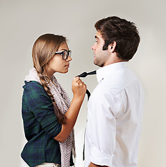 Image showing Angry, fear and couple in a fight on a studio background with conflict, frustrated and toxic. Anger, together and a scared man and woman grabbing for argument, confrontation and a threat in marriage