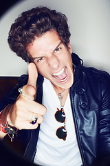 Image showing Man, gun finger and studio portrait with shouting, crazy or sign for attitude in spotlight by white background. Rock person, artist or musician in vintage leather jacket, edgy clothes or point at you