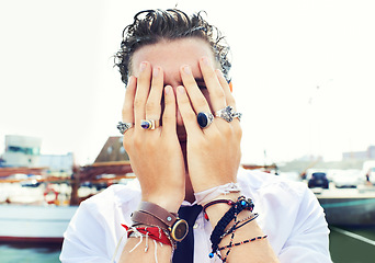 Image showing Hands, rings and accessories with a man in in the harbor by the sea for fashion or style. Jewelry, bracelet and fingers on the face of a young person for trendy or edgy expression by the pier