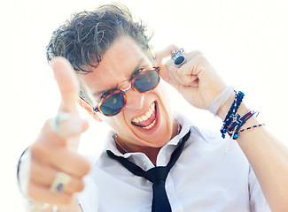 Image showing Man, gun finger and portrait with sunglasses, crazy and sign language for punk attitude by white background. Rock person, shouting and shooting with vintage jewelry, edgy clothes and point at you
