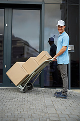 Image showing Box, portrait or trolley with a happy delivery guy by office for entrance for online shopping or product. Apartment, hand truck or courier man with stock by a home for ecommerce service or package