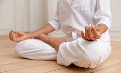 Image showing Zen, lotus and yoga, hands of woman on floor in gym for peace and mindfulness training. Relax, meditation and mind challenge, girl in workout for chakra balance, spiritual care and soul wellness.