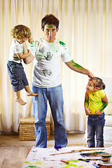 Image showing Family, paint and messy children on dad, childhood and crazy in living room at home, bad and naughty. Father and kids, painting and art on clothing, energy and punishment for behavior by tired man