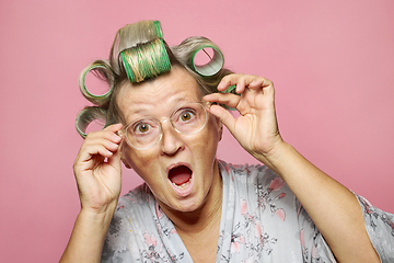 Image showing surprised senior women with hair rollers