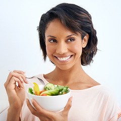 Image showing Smile, health and woman with a salad in studio with vegetables for wellness, organic or diet. Happy, nutrition and young female person from Mexico eating healthy meal with produce by white background