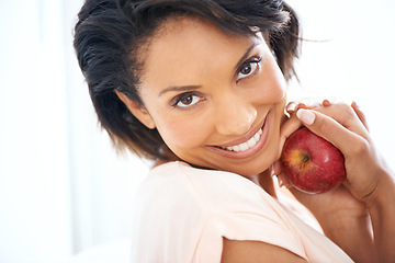 Image showing Health, apple and portrait of woman in a studio for wellness, nutrition and organic diet. Smile, vitamins and happy young female person eating a fruit for healthy vegan snack by white background.