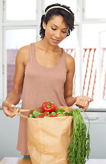 Image showing Kitchen, vegetables and woman with groceries, healthy food and wellness with retail, package and customer. Person, client and girl with nutrition, home and meal with brown bag, thinking and diet